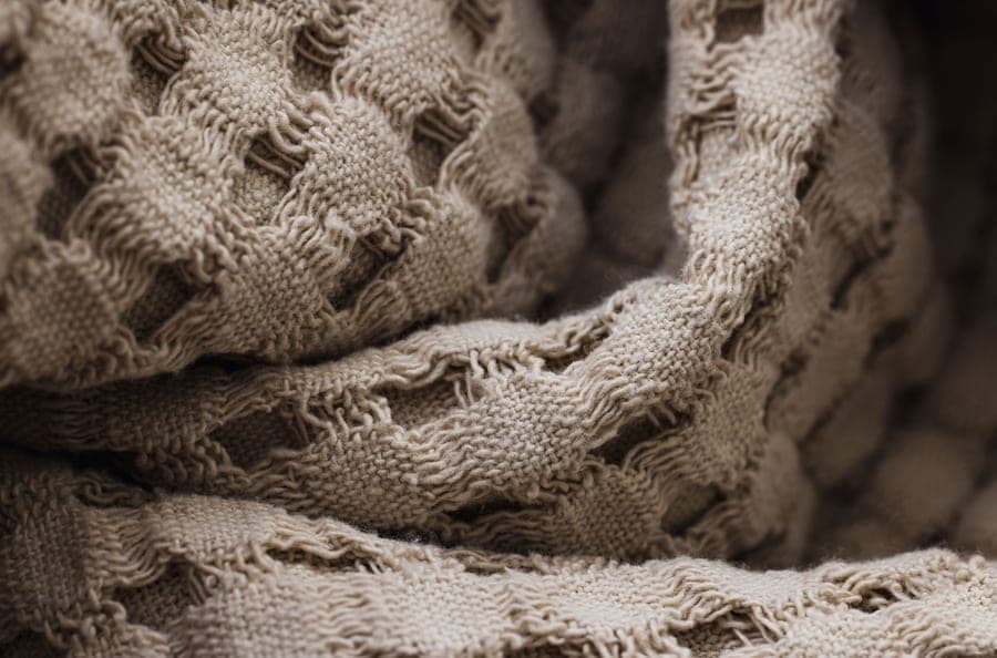 Close-up of an open waffle-weave cotton bath sheet in natural beige