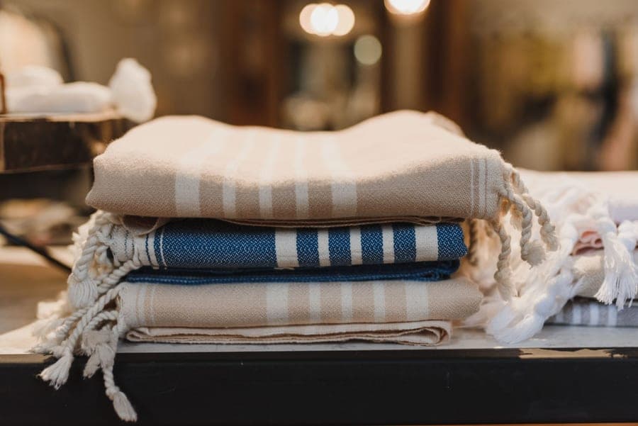 Folded Turkish peshtemal towels in muted colors