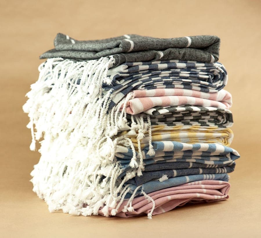 Oversized fringed Turkish cotton towel draped over a chair