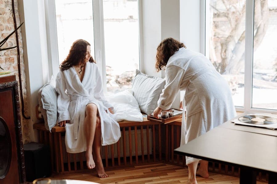 Waffle weave cotton bathrobe folded on a bench