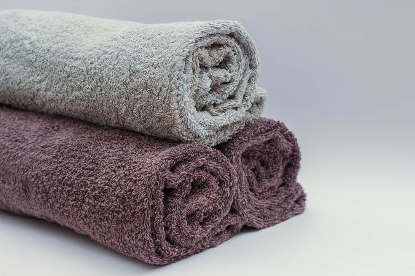 A large bath sheet and a standard bath towel laid out for size comparison
