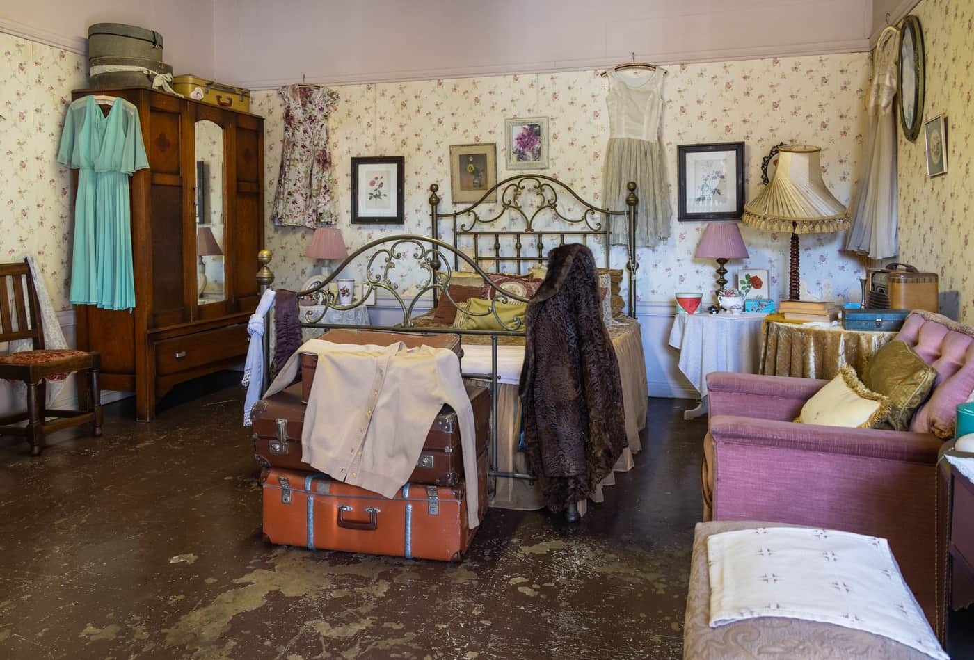 A terry bathrobe beside a lighter dressing gown on a rail