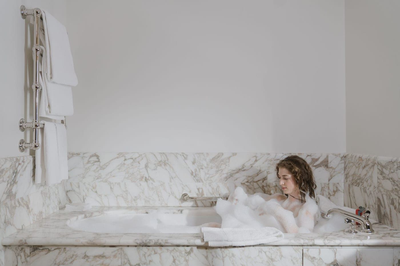 A finely woven luxury cotton bath towel folded on a marble surface