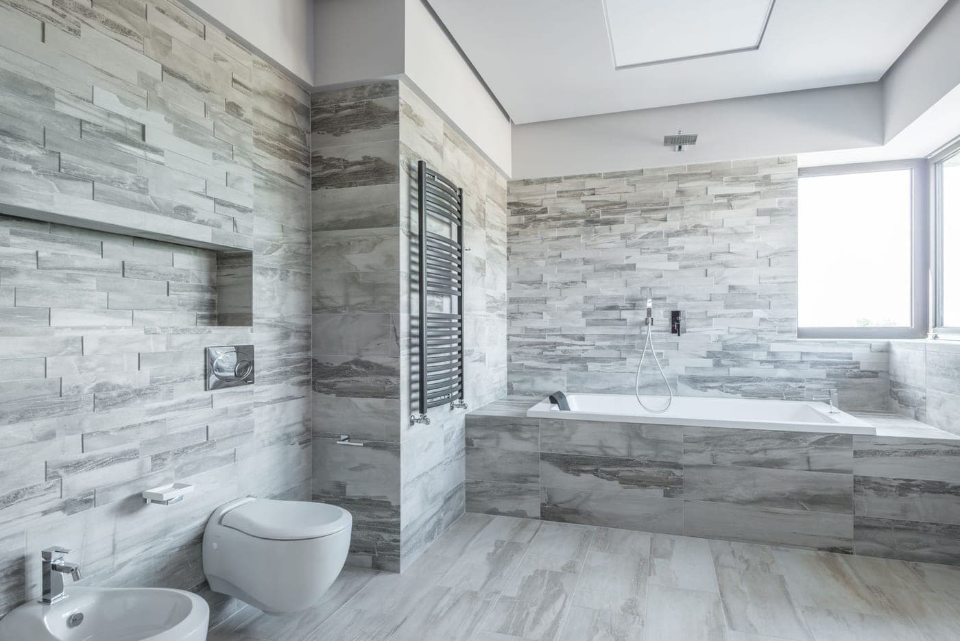 A diatomaceous stone bath mat on a tiled bathroom floor