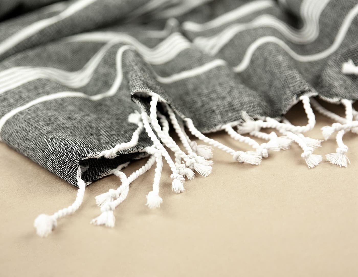 Folded striped Turkish peshtemal towels with knotted fringe