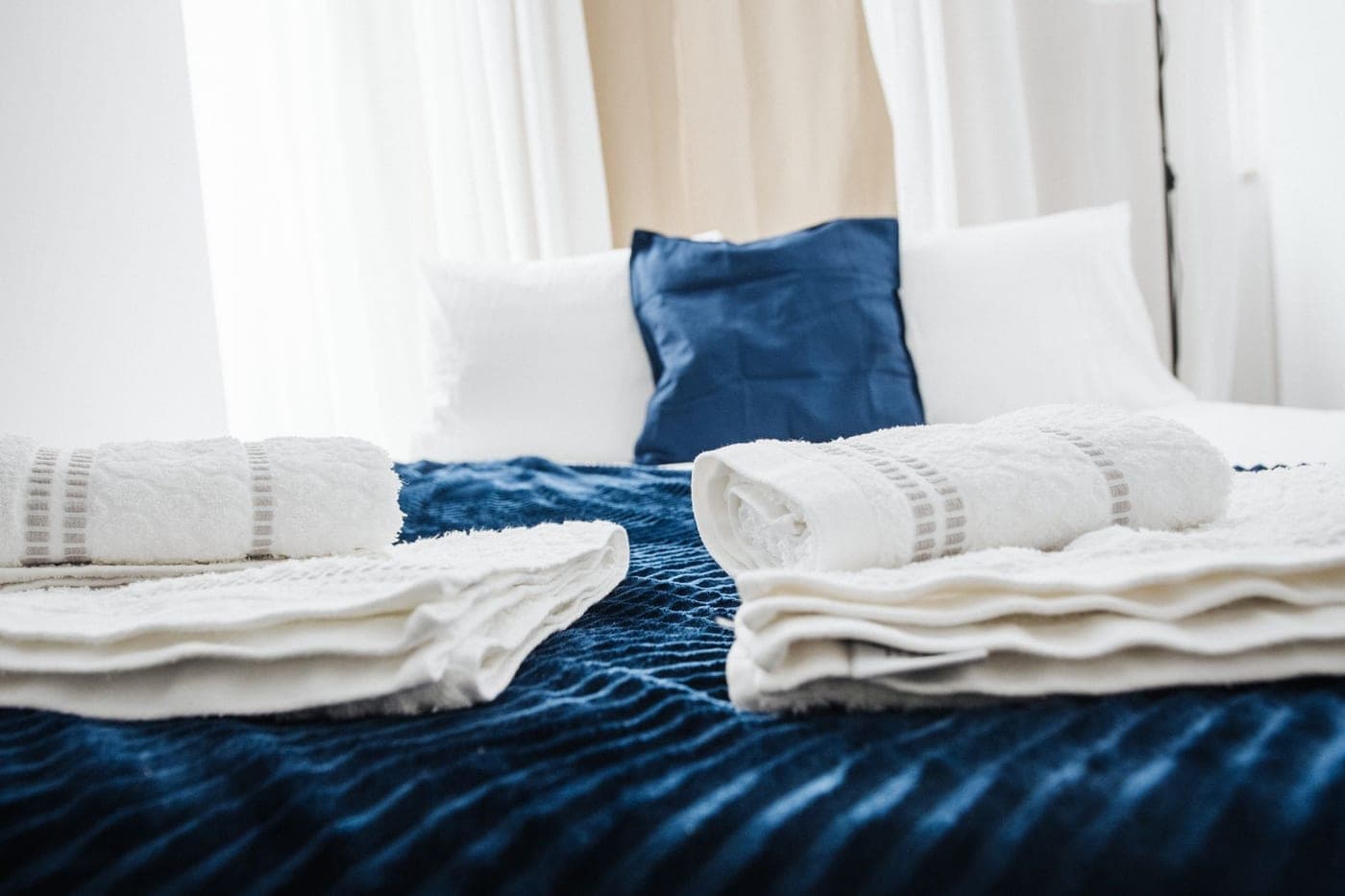 A plush Turkish cotton bath towel folded on a bed