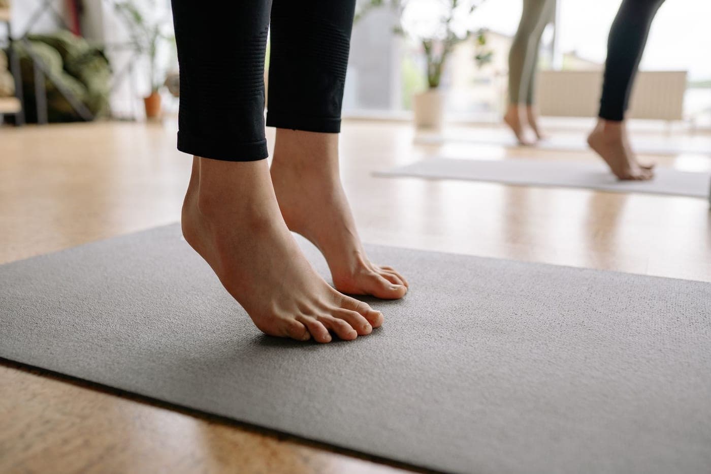 A cotton bath mat and a plush foam-backed mat side by side