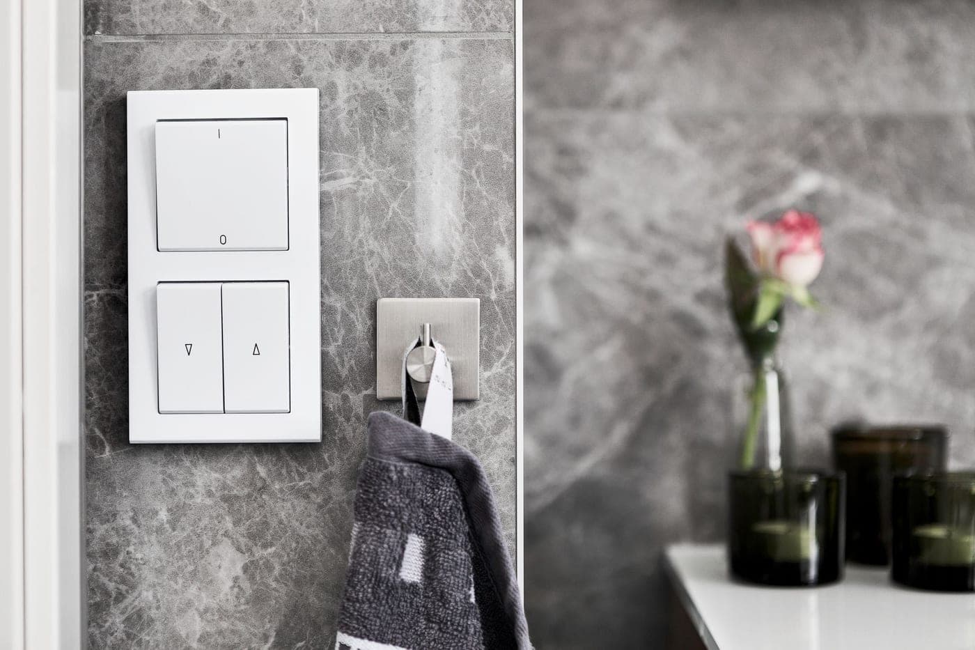 Hand towels of different sizes hanging from rails and rings