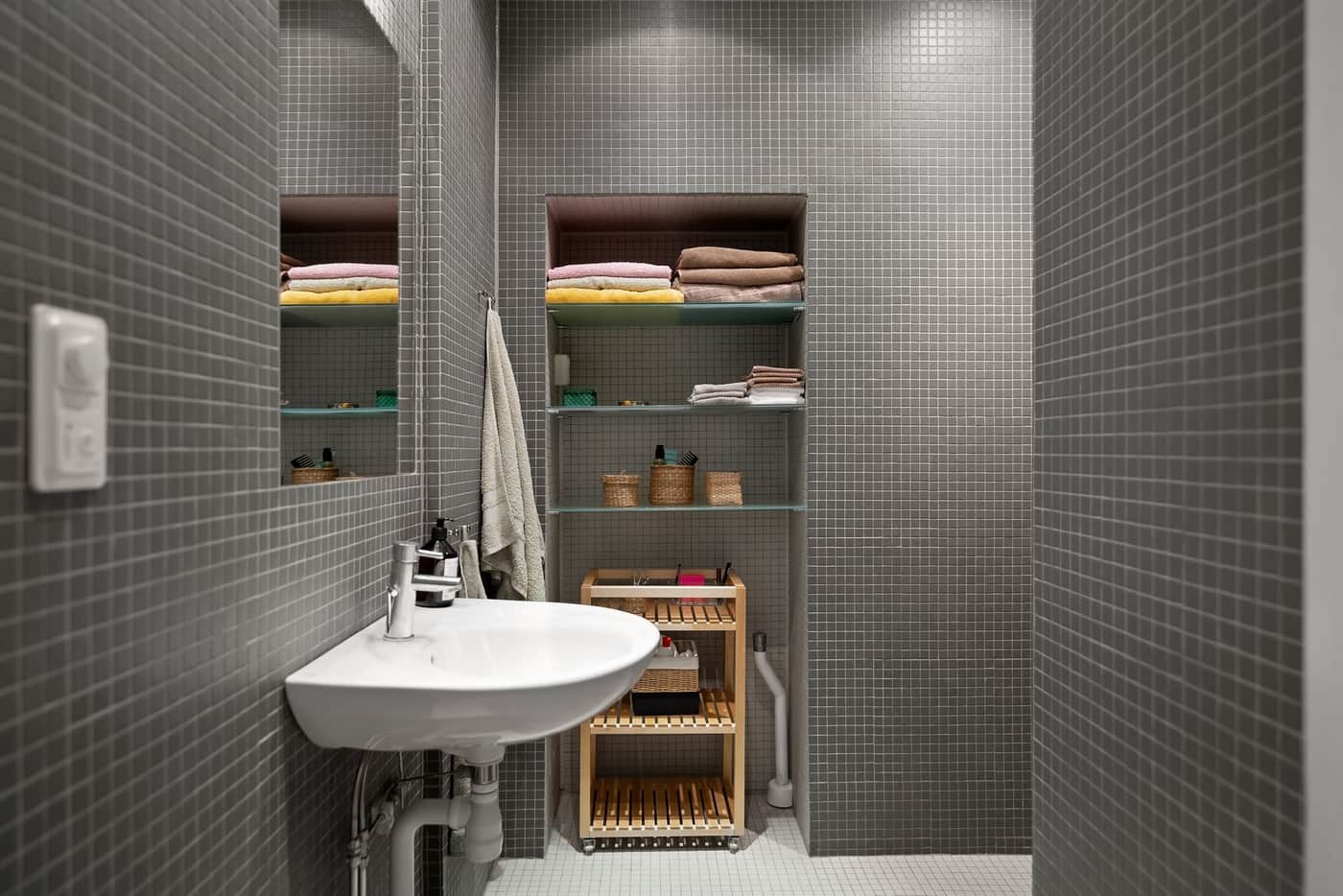 Neatly folded towels stacked on open shelving
