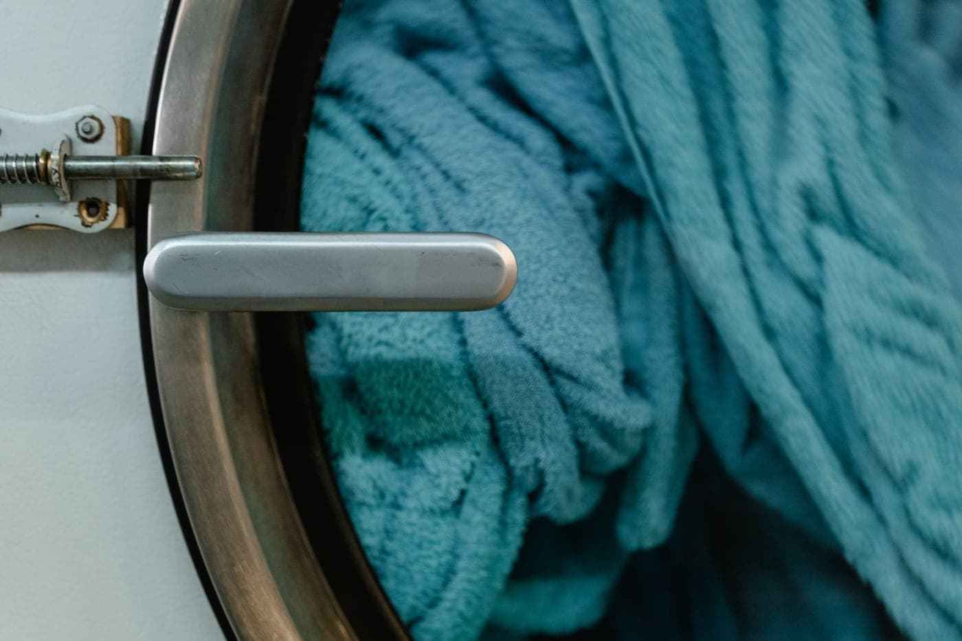 A bath mat going into a front-loading washing machine
