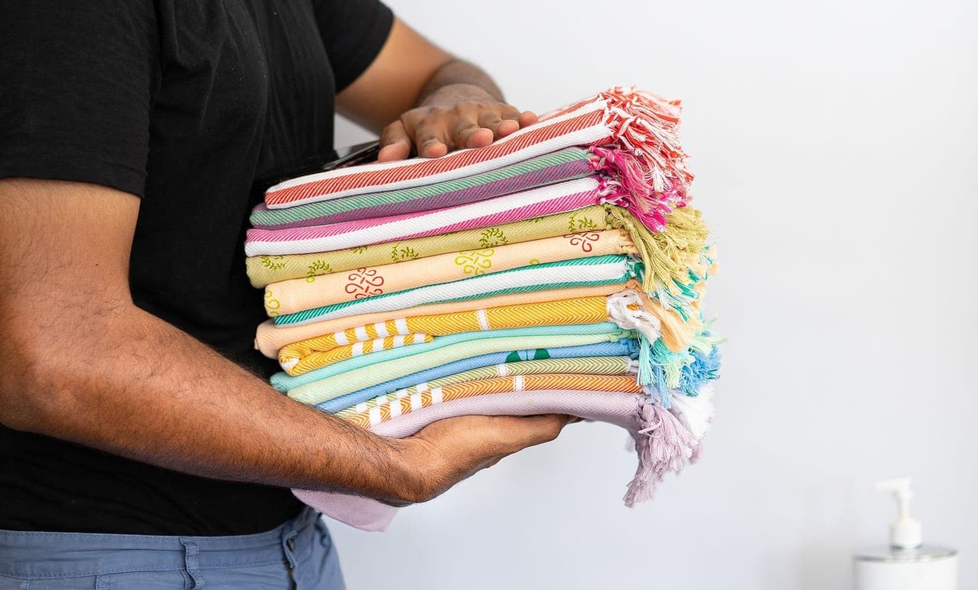 Traditional hand-loomed peshtemal cloths stacked in a pile