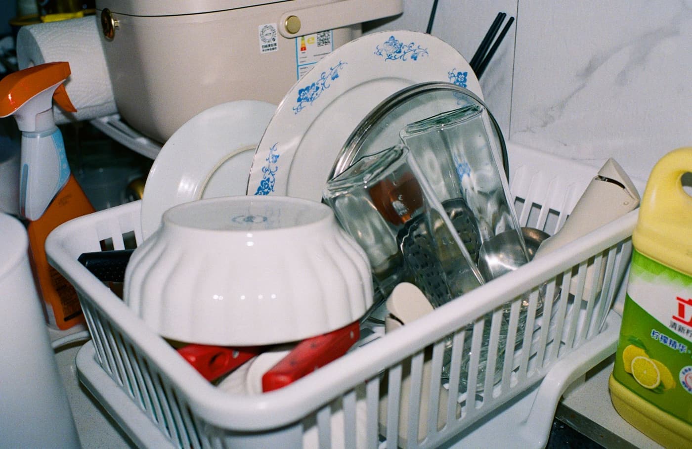 White vinegar and baking soda beside a laundry basket of towels
