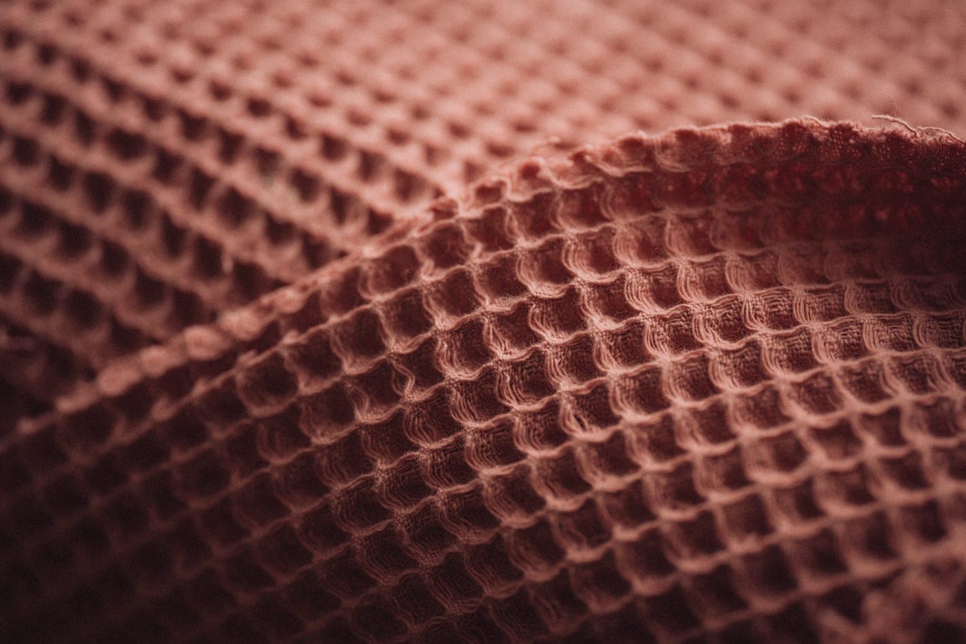 A waffle weave towel and a terry towel side by side showing the two textures