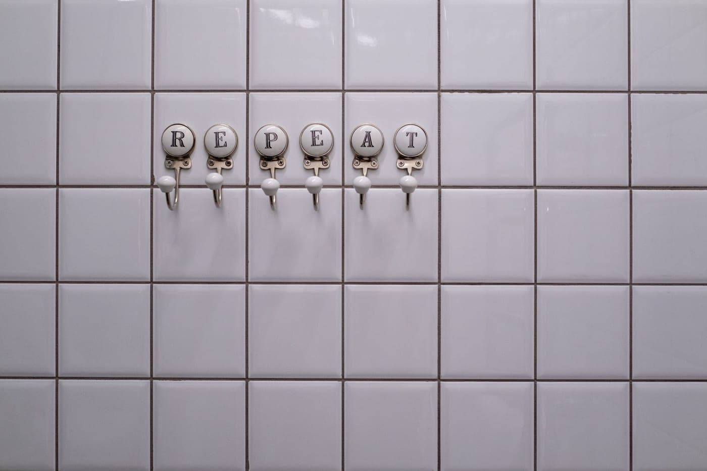 A damp towel hanging on a hook in a humid bathroom